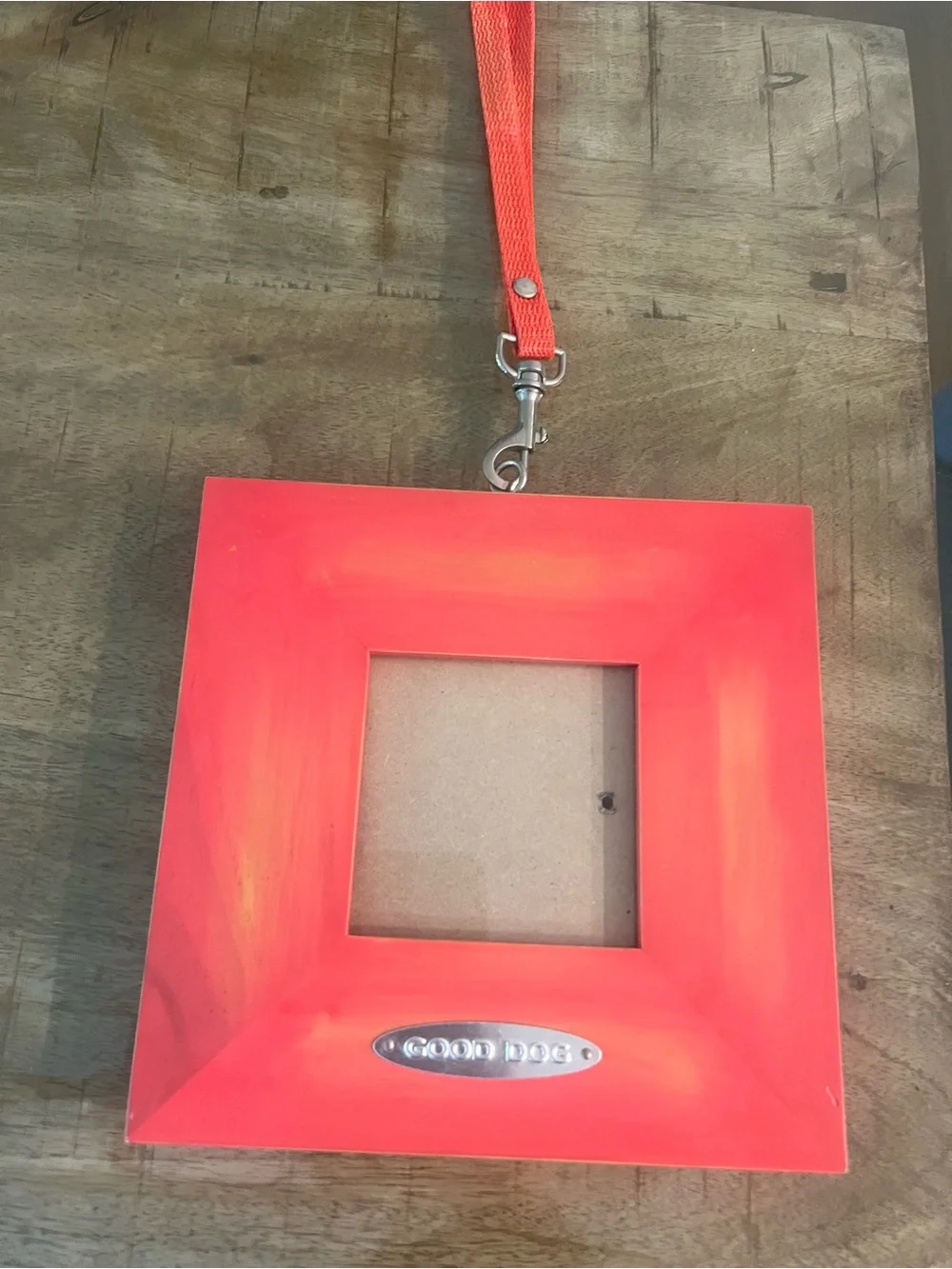 red/orange square photo frame features a 